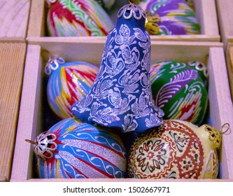 Interesting Christmas ornaments - handmade ceramic bell & baubles in Central Asian Style in wooden box. Closeup. Selective focus - Powered by Shutterstock