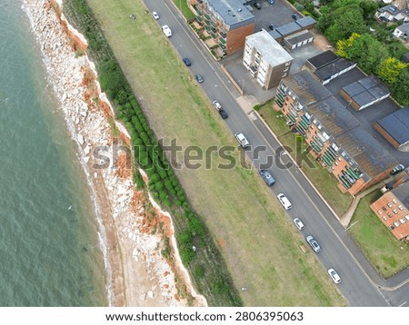 Interesting drone top down view of the famous Jurassic cliffs of Hunstanton, Norfolk, UK. Showing the large amount of cliff erosion together with the chalk and iron infested rocks. Apartments, overlooking the sea are on the right.
