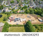 Interesting drop UAV view of a new detached bungalows being built within a small building plot in Cambridgeshire, UK. Established homes surround the site.