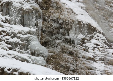 Interesting icicles from rocks and rocky wall.