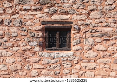 An interesting old window in a stone wall in the village of Nether Stowey in Somerset, United Kingdom