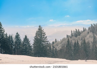 Interesting places for people to hike in the winter is in the snow-covered mountains, where snow peaks rise above the treetops