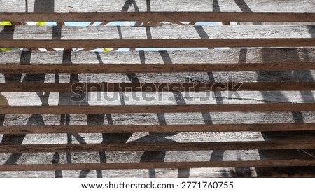Interesting shadow patterns of the wooden backyard garden roof.