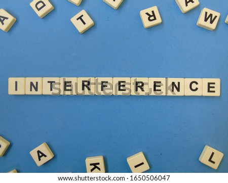 Interference, word cube with background.