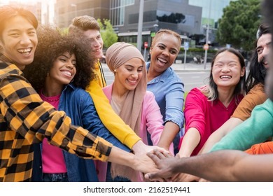 Intergenerational and multiethnic family - group of people joining hands together - concept of trust, self-esteem and collaboration between diverse people - Powered by Shutterstock