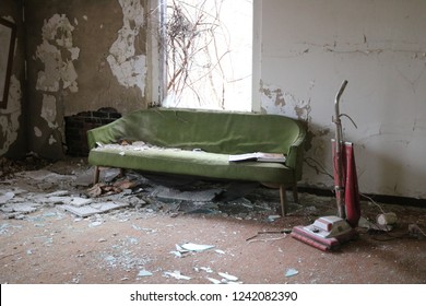 Interior of abandoned building with old couch and peeling paint walls - Powered by Shutterstock