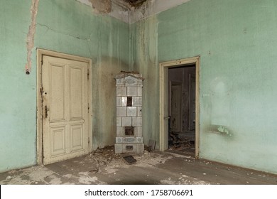 Interior of an abandoned mansion. Empty room deserted and derelict. The interior of an abandoned castle. Damaged and demolished fireplace