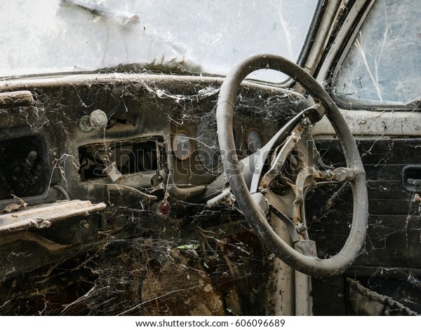 Interior of\
abandoned old car with spider web, damaged dashboard, creepy and \
gloomy atmosphere, scary\
background