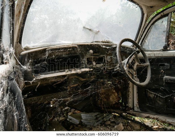 Interior of\
abandoned old car with spider web, damaged dashboard, creepy and \
gloomy atmosphere, scary\
background