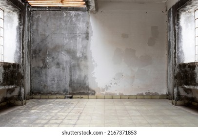 Interior Of Abandoned And Ruined House With Broken Wall. Old Interior With Broken Concrete Wall. Old Brick Wall