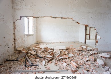 Interior Of Abandoned And Ruined House With Broken Wall