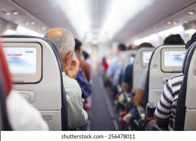 Interior of airplane with passengers on seats waiting to taik off.