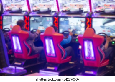 Interior Arcade Game And Entertainment Zone Race Car Machine Game Blur For Background