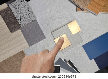 interior architect chose material samples contains gold stainless, travertine tile, roller blind drapery swatch, wooden vinyl flooring tile, interior fabric wallpaper, quartz, laminate. top view.