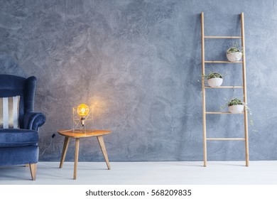 Interior With Armchair, Copper Lamp, Side Table And Flower Stand