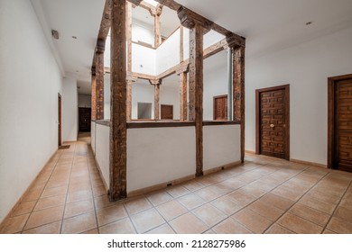 Interior atrium of a renovated vintage house with exposed wooden beams and columns