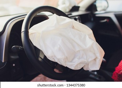 Interior Of A Automobile Or Car Involved In A Vehicle Crash With A Deployed Steering Column Airbag.