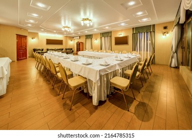 Interior Of Banquet Hall With Shared Served Table For Corporate Holiday Celebration