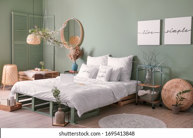 Interior Of Beautiful Modern Bedroom With Spring Flowers