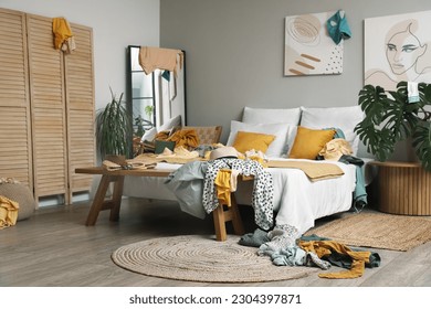 Interior of bedroom with dirty clothes