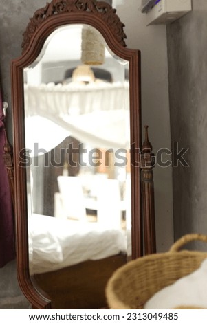 interior of a bedroom hotel with full body mirror with vintage style