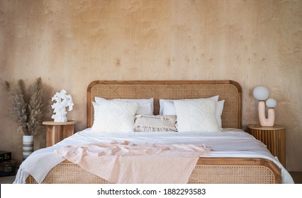 Interior of bedroom with wooden double bed white pillows. wood  wall in the room in rustic cottage. Stylish and comfort hotel accommodation with copy space