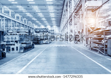 The interior of a big industrial building or factory with steel constructions