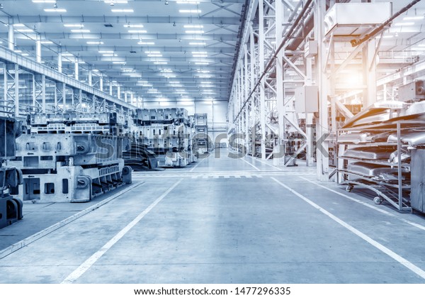 The interior of a big industrial building\
or factory with steel\
constructions