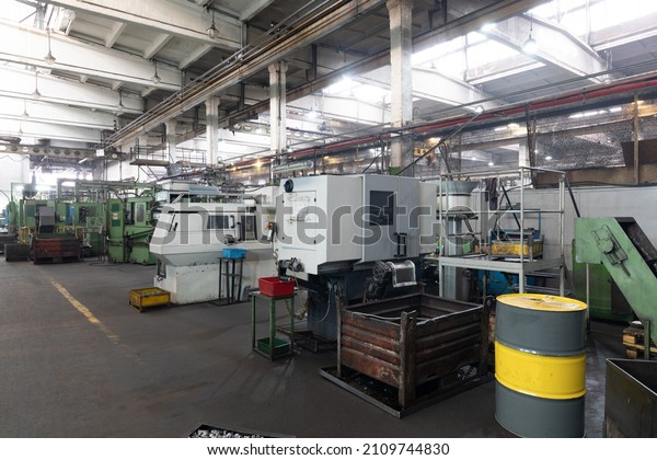 The interior of a big industrial building of\
factory with steel constructions. Plant of car production.\
Industrial and machinery\
concept