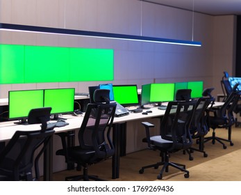 Interior Of Big Modern Security System Control Room With Blank Green Screens, Workstation With Multiple Displays, Monitoring Room With At Security Data Center  Empty Office, Desk, And Chairs At A Main