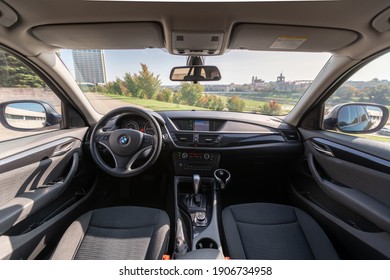 Interior Of BMW X1 2012 Year Compact Sport Utility Vehicle. Beautiful Sunny Cityscape Background.