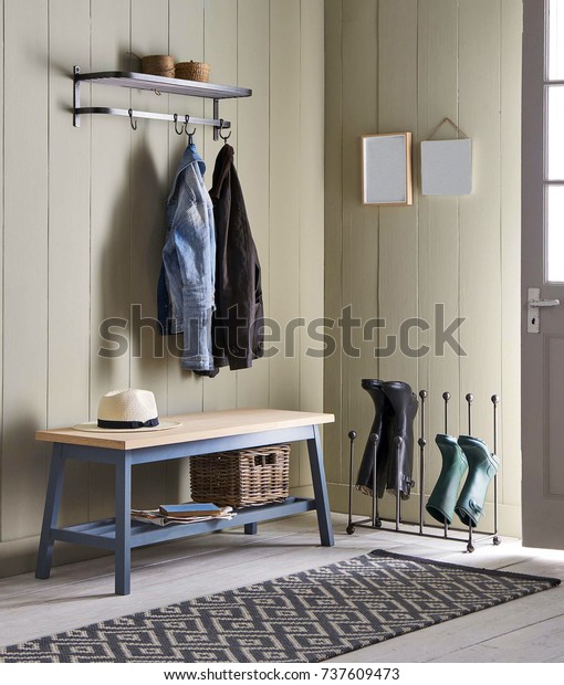 Interior
of bright hallway home. Hanging clothes on
door