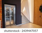 Interior of a building corridor with stairs and elevator