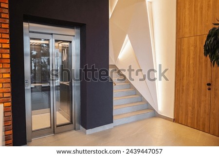 Interior of a building corridor with stairs and elevator