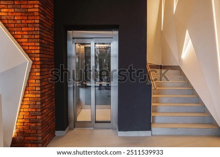 Interior of a building corridor with stairs and elevator