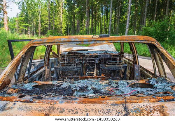 Interior of a burned-out\
car from behind