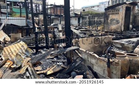 Interior of a burnt by fire house building. Burned wooden background.
