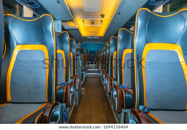 The interior of the bus. Leather seats. The concept\
is comfort in Autobus traffic. Public transport. Carriage of\
passengers. Traveling by bus. Luxury class public transport. Seats\
in a tourist bus. 