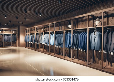 Interior of the business suit shop. Strict premium expensive suits hang in a row on hangers in large quantities - Powered by Shutterstock