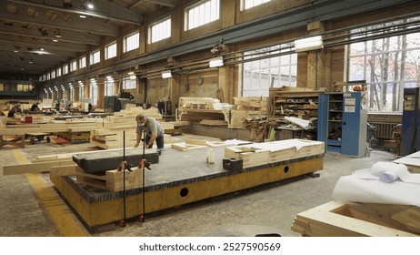 The interior of a bustling woodworking workshop featuring various machinery and raw materials. Stock Clip - Powered by Shutterstock