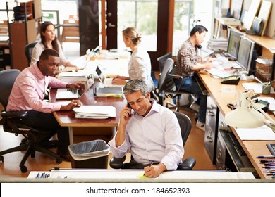 Interior Of Busy Architect's Office With Staff Working - Powered by Shutterstock