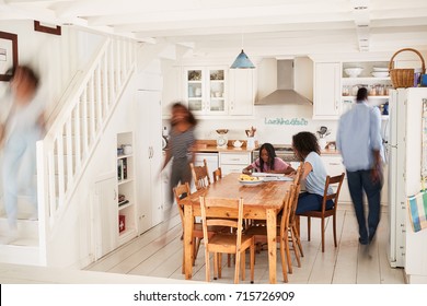 Interior Of Busy Family Home With Blurred Figures - Powered by Shutterstock