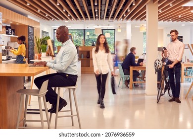 Interior Of Busy Office Coffee Shop With Businesspeople Working At Tables