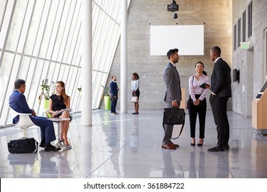 Interior Of Busy Office Foyer Area With Businesspeople