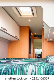 Interior Of A Camper Van With Double Bed And Skylight In The Ceiling