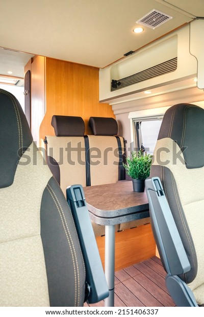 Interior of a camper\
van with table and\
seats