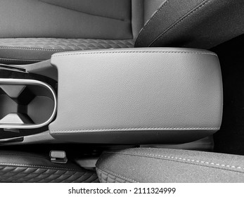The interior of the car. The central armrest of the car for the convenience of the hand. Black and white photo - Shutterstock ID 2111324999