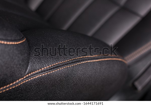 the interior of the car is covered with\
handmade genuine leather. black leather car seat. the view from the\
top. Visible quality\
stitching