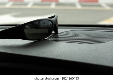 Interior Of The Car From The Inside. On The Front Panel Are Sun Glasses For The Driver. Concept: Protect Your Eyes From Bright Light While Driving.