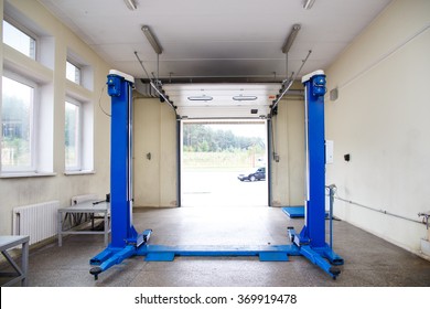 Interior Of A Car Repair Garage. Car Lift